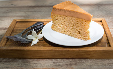 thai tea cake and three fork on wood plate