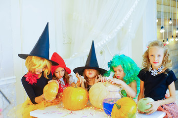 Happy group of children in costumes preparing for Halloween