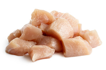 Pile of dices skinned deboned raw chicken breast isolated on white.