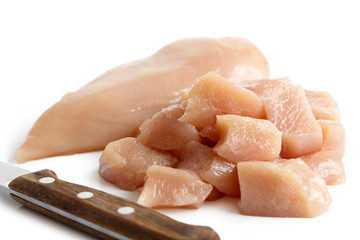 Whole skinned deboned raw chicken breast isolated on white.
