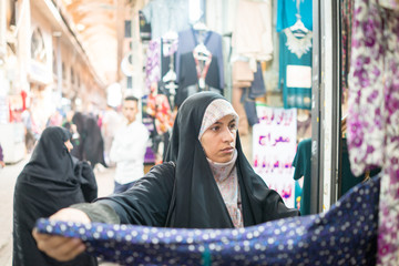 Beautiful Muslim woman spending time on traditional Iranian baza