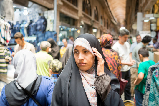 Beautiful Muslim woman spending time on traditional Iranian baza