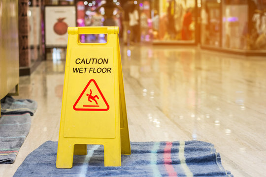 Sign showing warning of caution wet floor in the shopping store