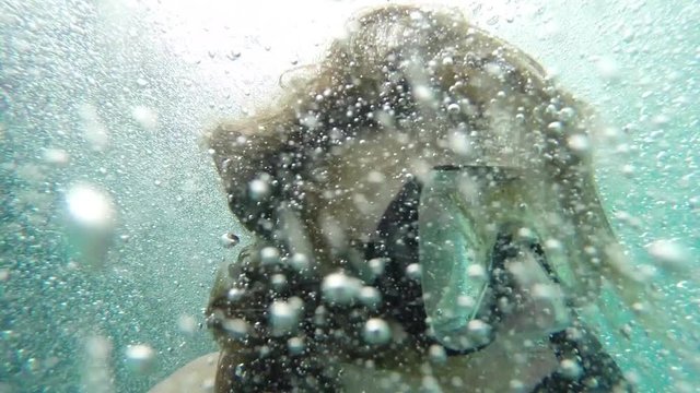 Snorkel in Caribbean, a male snorkeler backflips off a boat and launches into the Caribbean, the camera goes underwater with him, Belize tourism.
