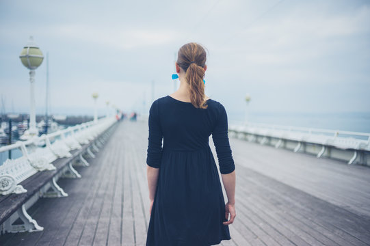 Young woman walking on the pier
