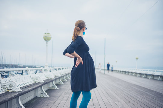 Young pregnant woman on the pier