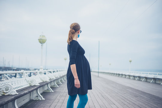 Young pregnant woman on the pier