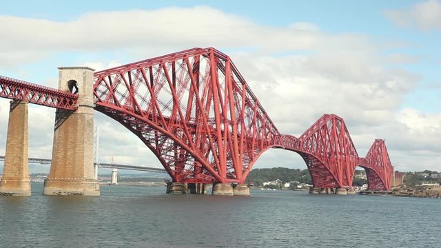 big red metal construction over river, commuters bridge Forth bridge Scotland