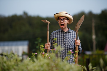 Farmer with shovel and rake screaming at the farm work © snedorez