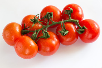 Branch red tomato cherry on a white background