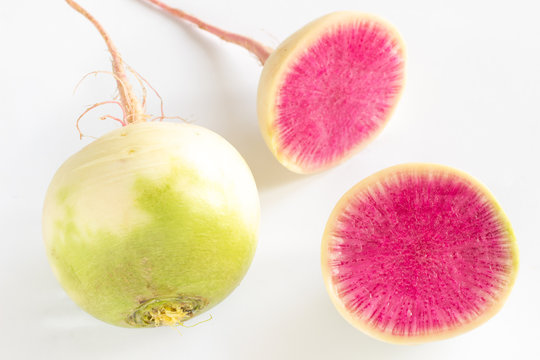 White radish with a pink core on a white background