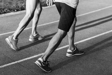 Fototapeta premium Black and white portrait of two men jogging