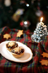Christmas pastry filled with apples, almonds and chocolate with star shaped cookies. Selective focus and festive background.
