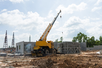 Construction site crane is used to placing precast concrete pane