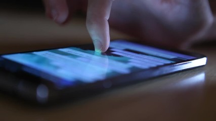 generic no brand mobile phone texting typing reading scrolling watching pictures close up finger modern technology smartphone