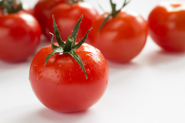 Red tomatoes on a white background