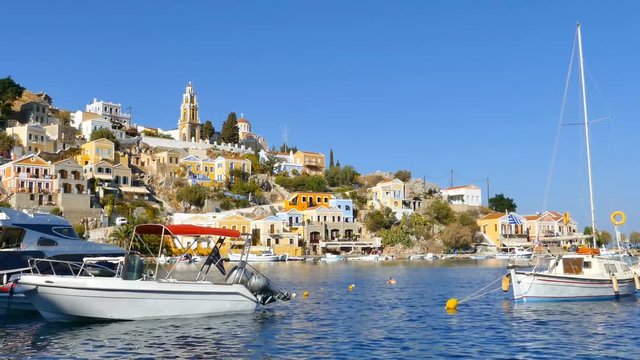 Symi island - Colorful houses and small boat footage at the heart of the village