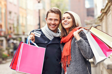 Happy couple shopping in the city