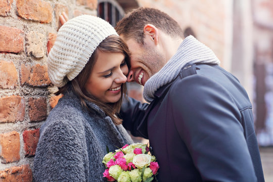 Young Couple Kissing In The City