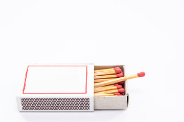 Matches stick in paper box close up isolated.