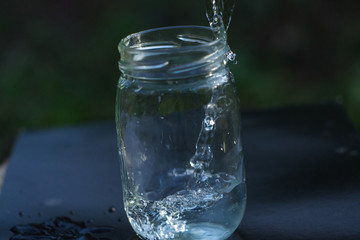 Apple falls into a jar of water