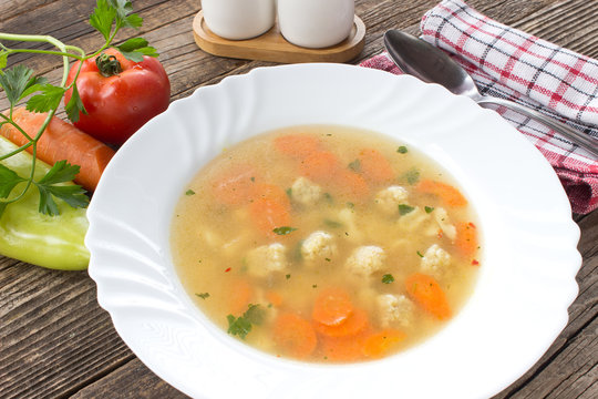 Soup with meatballs and vegetables in plate