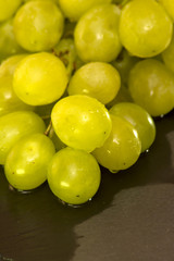 Bunch of grapes on a black slate stone