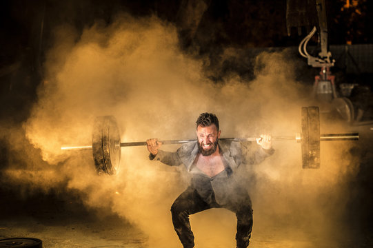 Man in smart jacket lifting weight