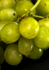 Bunch of grapes on a black slate stone
