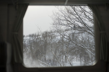 Snowy landscape through a train window