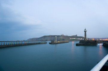 Fototapeta na wymiar Lighthouse, piers and navigation beacon