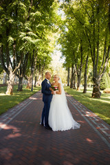 Newlyweds tenderly embraced in the park
