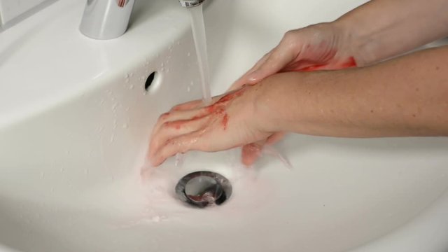 female washing bloody hands in a sink Stock Video | Adobe Stock