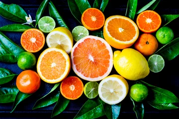 Foto op Plexiglas Assorted fresh citrus fruits with leaves © lblinova