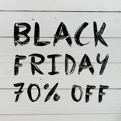 Black friday 70% off brush hand lettering on white painted rustic barn wooden planks. Sale banner.