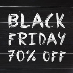 Black friday 70% off brush hand lettering on white painted rustic barn wooden planks. Sale banner.