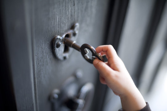 Young boy unlocking a door