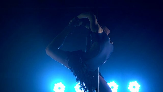 Pole dance woman. acrobatics on the pole