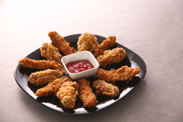 Grilled chicken on a plate standing the wooden table