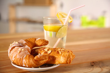 Croissant in the plate on the table