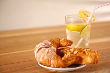 Croissant in the plate on the table