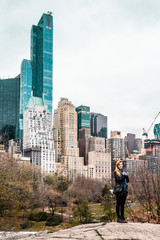 Fototapeta na wymiar Girl inf front of Buildings near Central Park in Manhattan, New