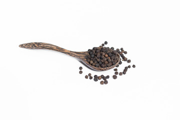 Black pepper in spoon wooden bowl isolated on white background