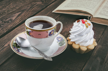 Coffee and cake. Vintage book on background