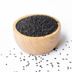 black sesame in wooden bowl on white background