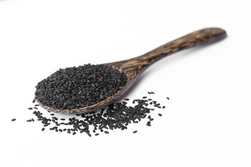 black sesame on wooden spoon isolated on white