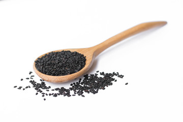 black sesame on wooden spoon isolated on white
