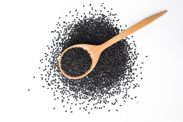 black sesame on wooden spoon isolated on white