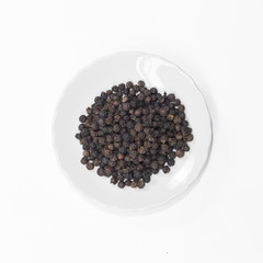 Fototapeta na wymiar Black pepper in disc isolated on white background