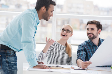 Young group of architects discussing business plans